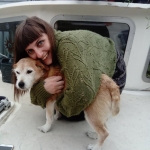 A Bluefruit colleague hugs their small dog.