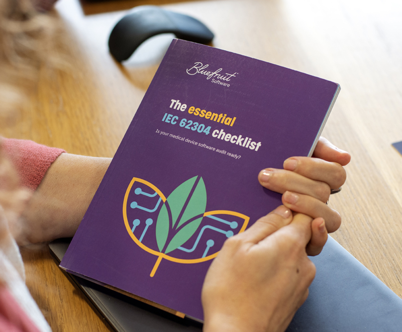 A person is holding a book in their hand. It says 